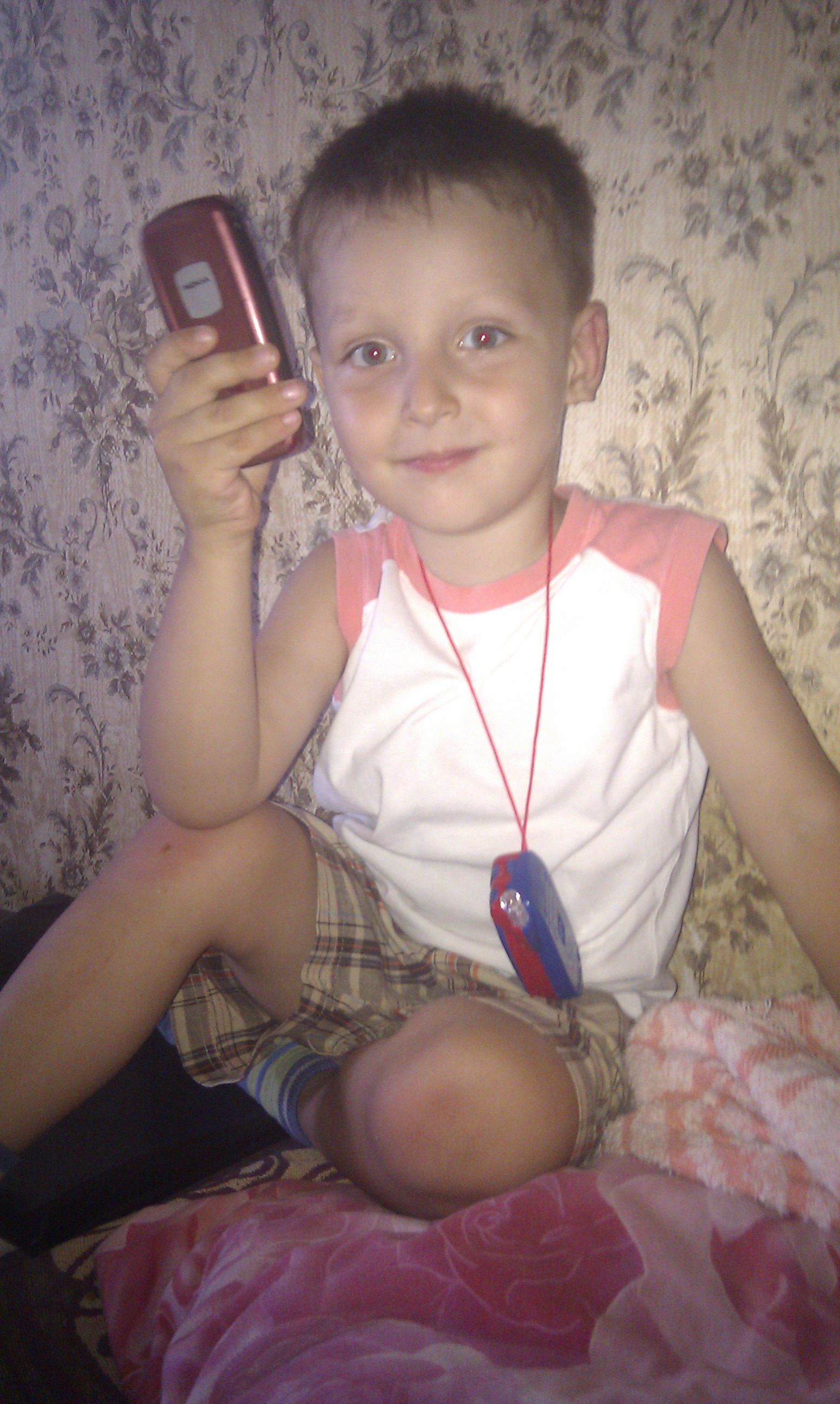 Ivan holding a phone as a child in 2012